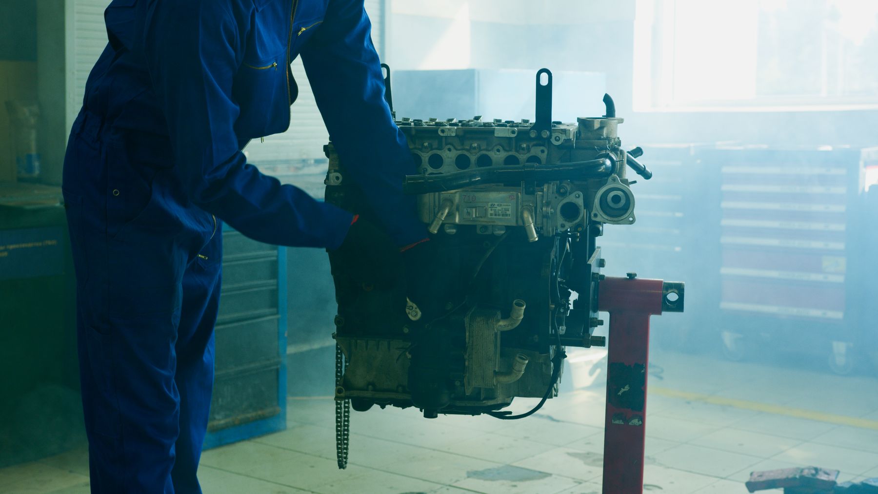 Mechanic inspecting an engine on a stand