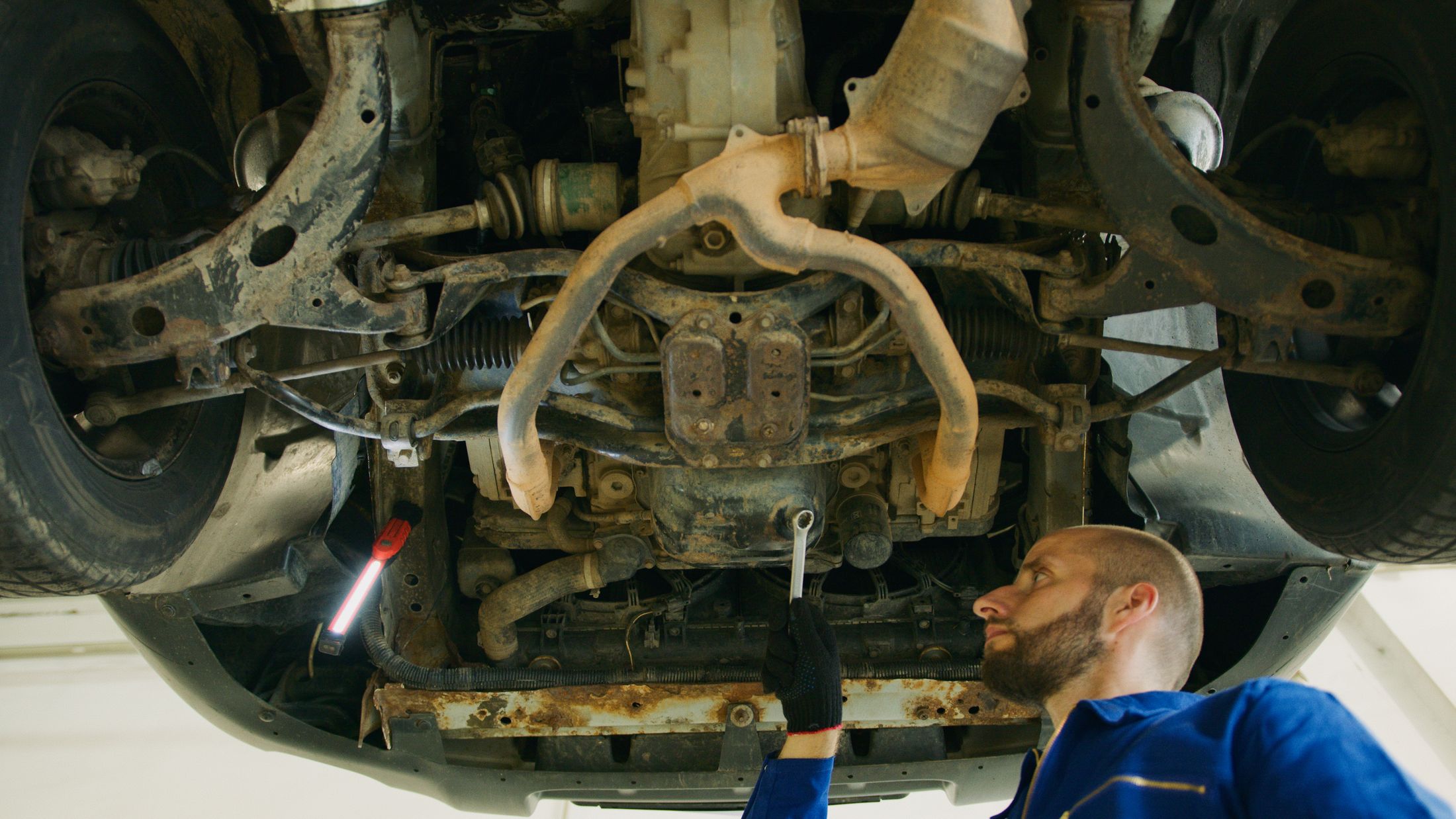 Mechanic working under a raised car